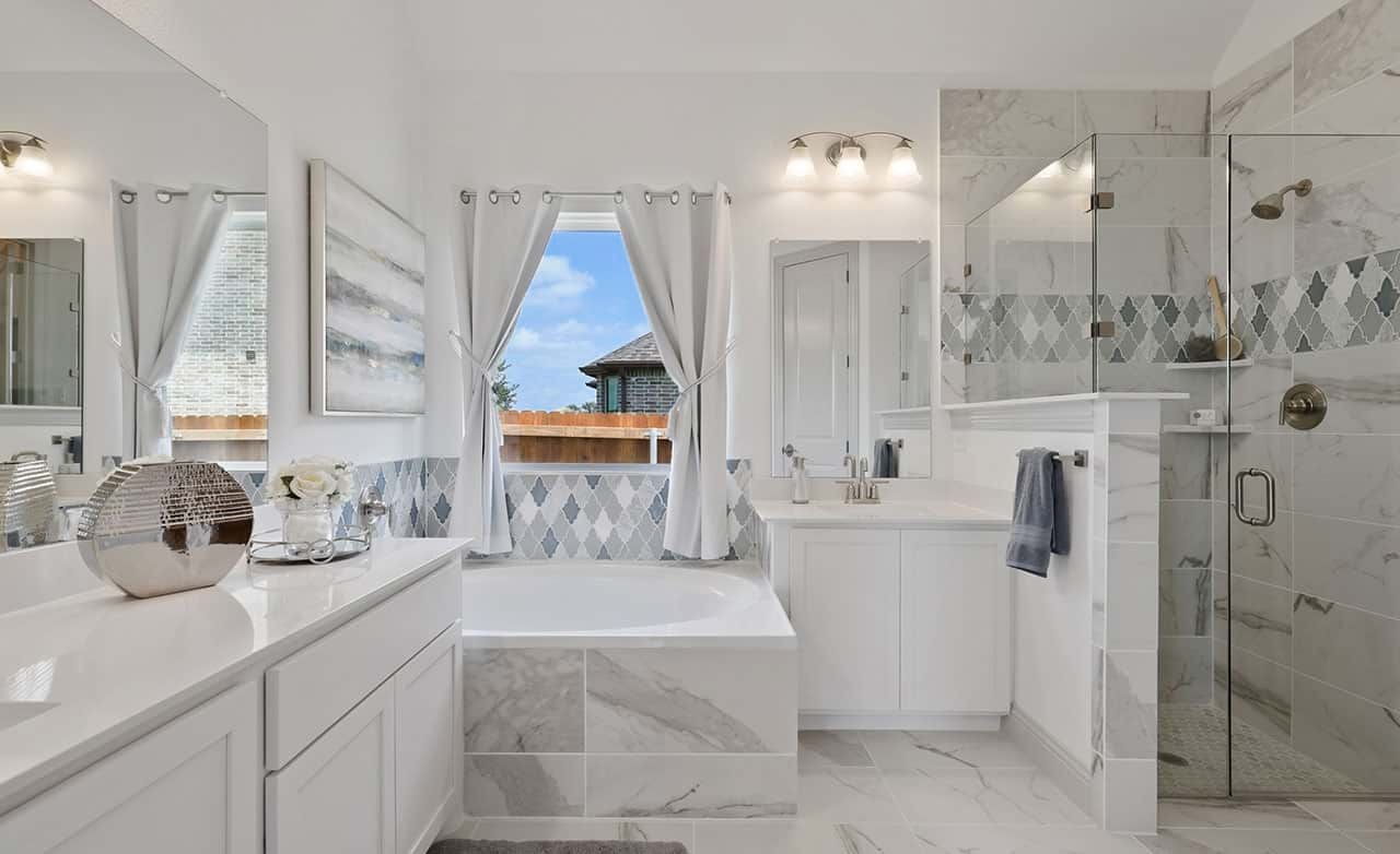 Luxurious bathroom with marble tiles, freestanding tub, glass shower. Thompson Farms.