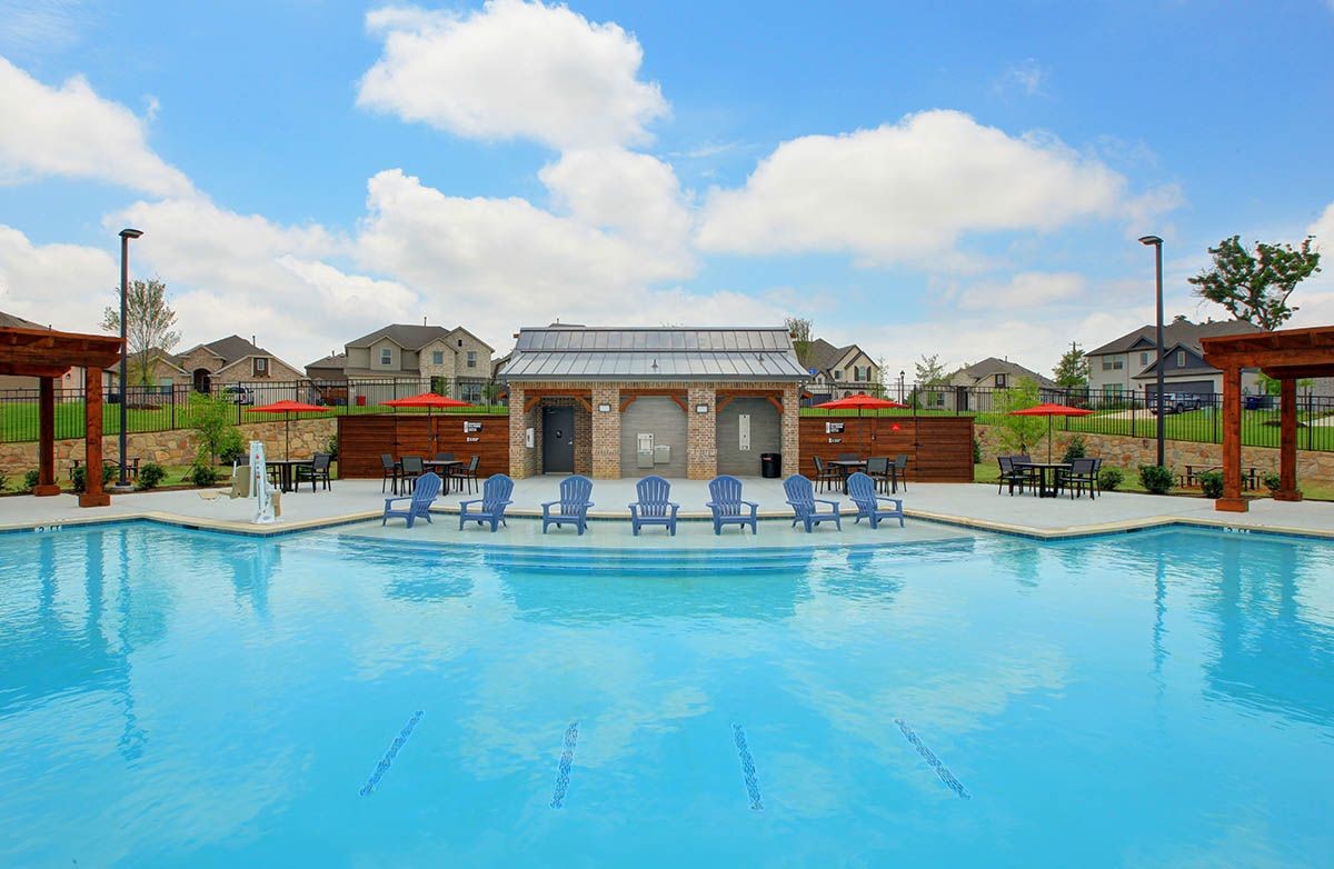 Luxurious community pool with cabana, brick and metal accents. Thompson Farms homes visible in background.