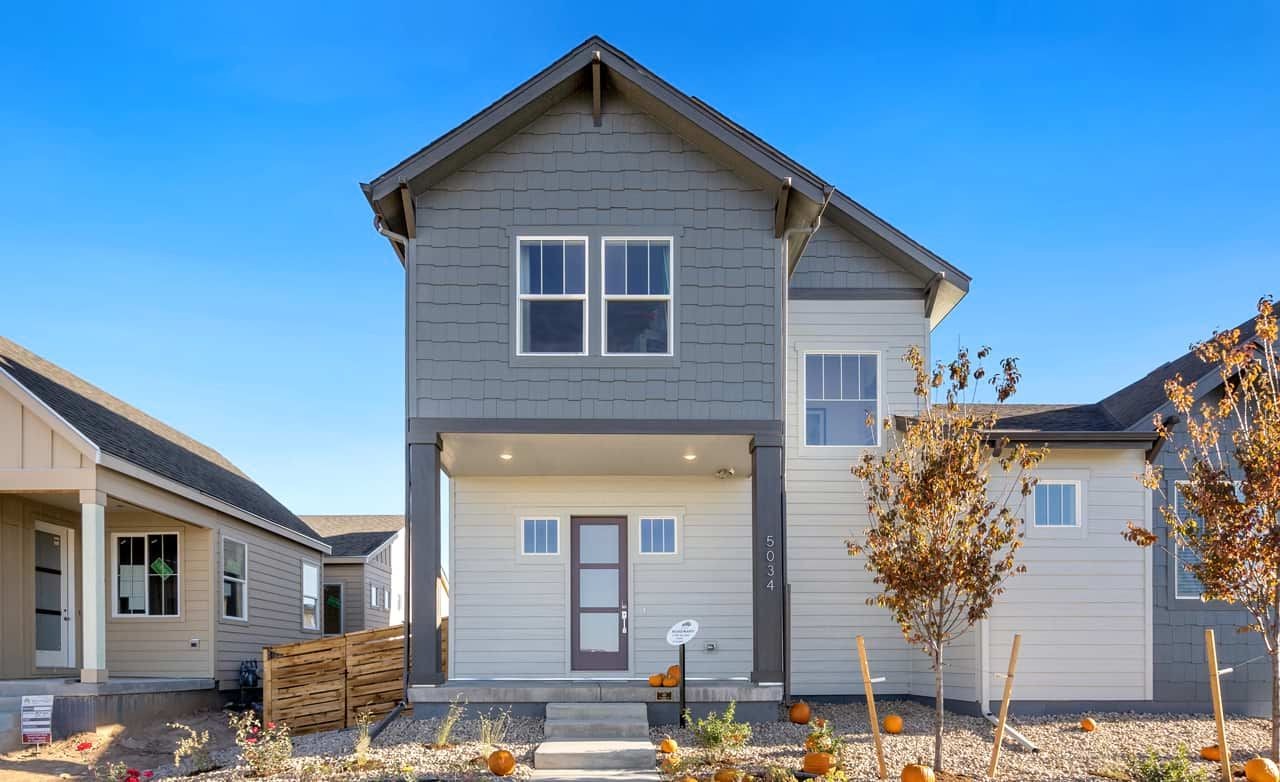 Modern two-story house with gable roof, subtle grey siding, near Trailside on Harmony, Colorado community.