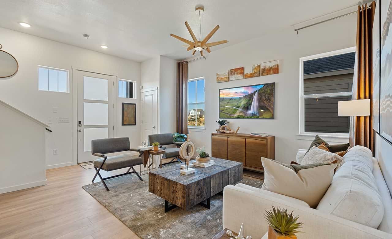 Modern living room features rustic wood coffee table, contemporary decor, Trailside on Harmony, stylish design.