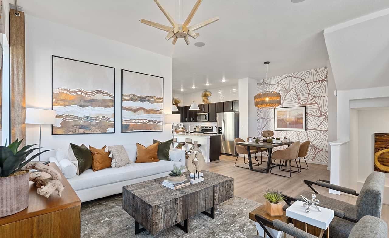 Elegant living room with abstract art, wooden accents in Trailside on Harmony community, contemporary decor.